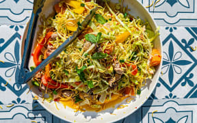 Crispy Citrus Chicken Salad on a blue and white tile background