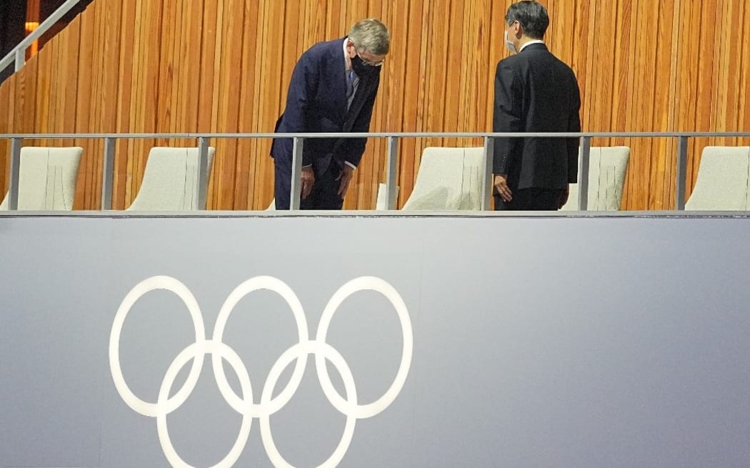 23 July 2021, Japan, Tokio: Olympics: Opening ceremony at the Olympic Stadium. Thomas Bach (l) from Germany, President of the International Olympic Committee (IOC), bows to the Japanese Emperor Naruhito.