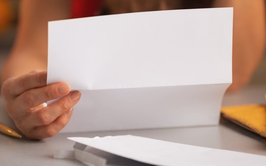 Close-up of a woman reading a letter
