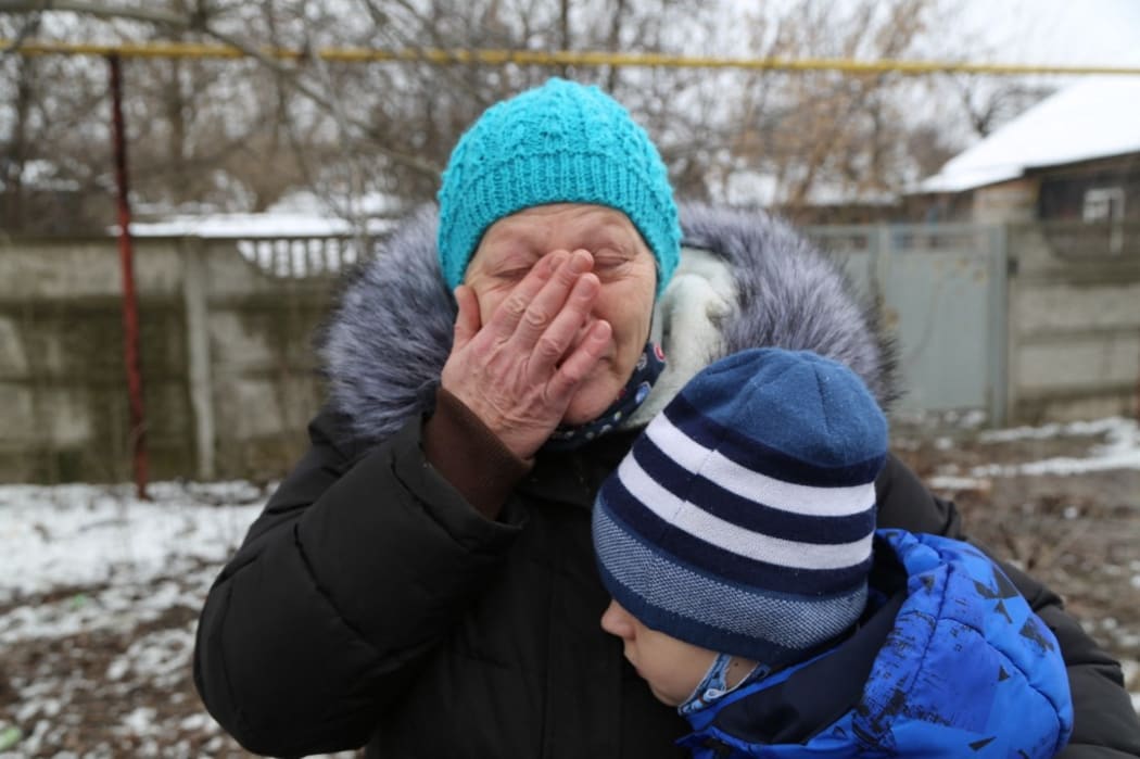 A view from Grabari village as a woman and her grandchild speaking after a shelling, in the pro-Russian separatists-controlled Donetsk, Ukraine on March 5, 2022.