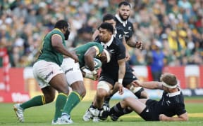 New Zealand's number eight Ardie Savea (C) tackles South Africa's flanker Siya Kolisi (2nd L) during the Rugby Championship Test match between South Africa and New Zealand at the Ellis Park Stadium in Johannesburg on August 31, 2024. (Photo by PHILL MAGAKOE / AFP)