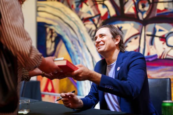 Australian author and journalist Trent Dalton signing books.