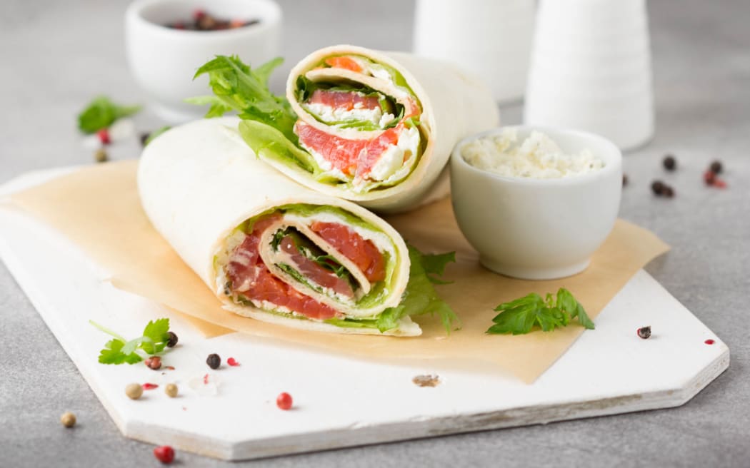 Tortilla with salmon, lettuce and cream cheese.