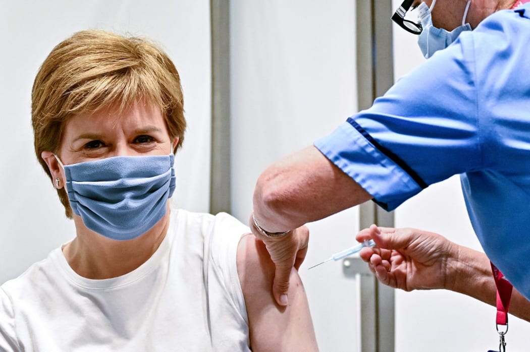 Scotland's First Minister Nicola Sturgeon receives her second dose of the Oxford/AstraZeneca Covid-19 vaccine, administered by staff nurse Susan Inglis at the NHS Louisa Jordan vaccine centre in Glasgow.