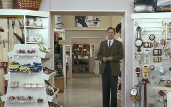 Man in suit in a general store.