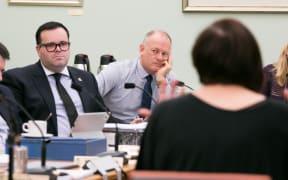 National MPs Paul Foster-Bell (left) and Jono Naylor (right) listen to Jan Logie (foreground) speak to the Justice and Electoral committee on her Domestic Violence-Victim's Protection Bill.