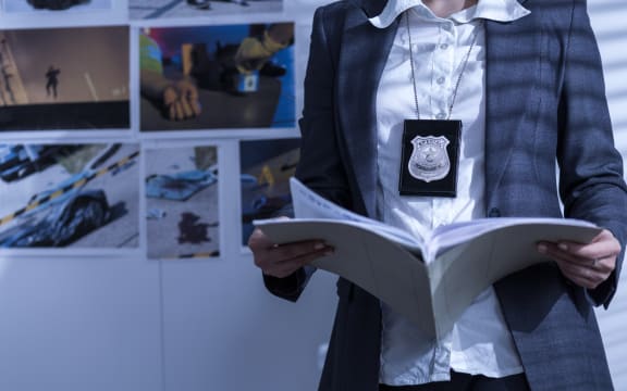 Police woman is reviewing files and documents.
