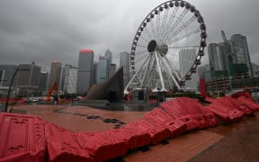 Barricades are blown down in the Central district as the typhoon signal number 10 is hoisted as Typhoon Wipha moves towards Hong Kong on July 20, 2025. (Photo by Peter PARKS / AFP)