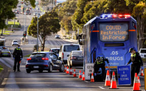 Police pull vehicles aside at a checkpoint in the locked-down suburb of Broadmeadows in Melbourne on July 2, 2020.