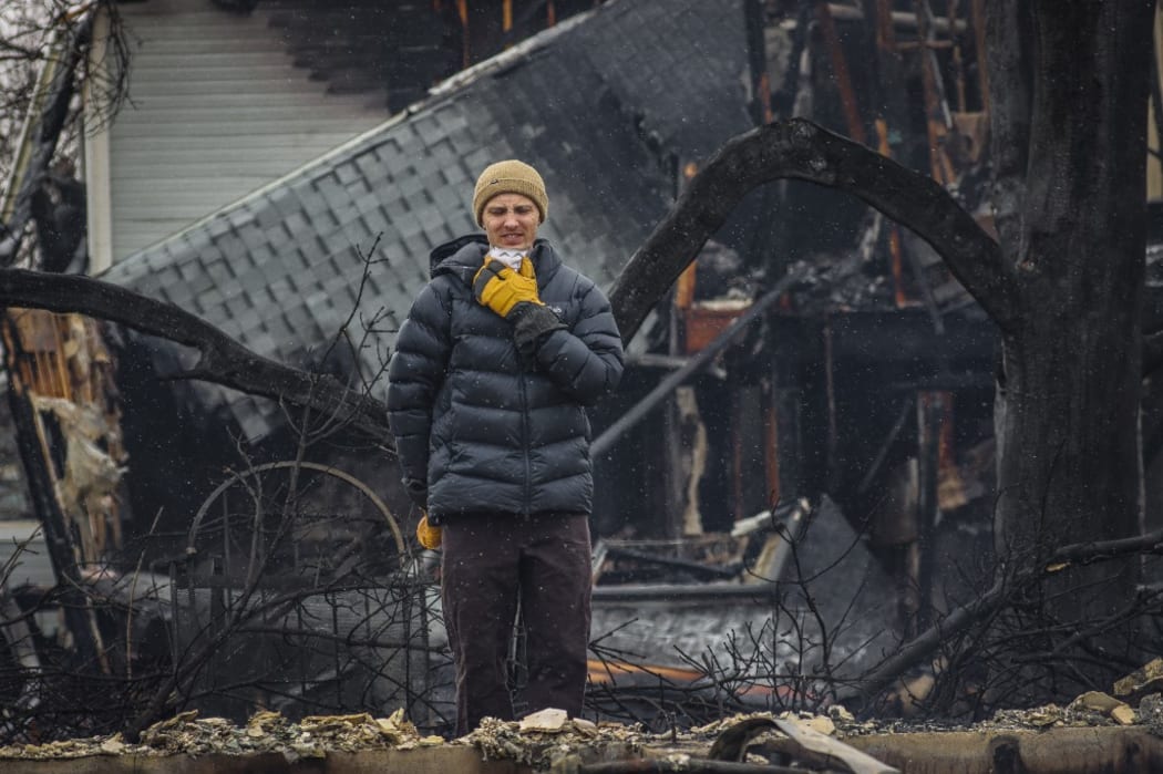 LOUISVILLE, CO - DECEMBER 31: Talis Ozols takes in what remains of his apartment at the Wildflower Condos on December 31, 2021 in the aftermath of the Marshall Fire.