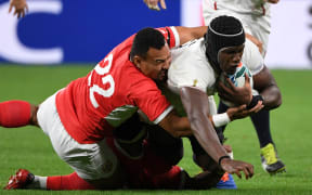 James Faiva tackles England lock Maro Itoje during Tonga's 2019 Rugby World Cup opener.