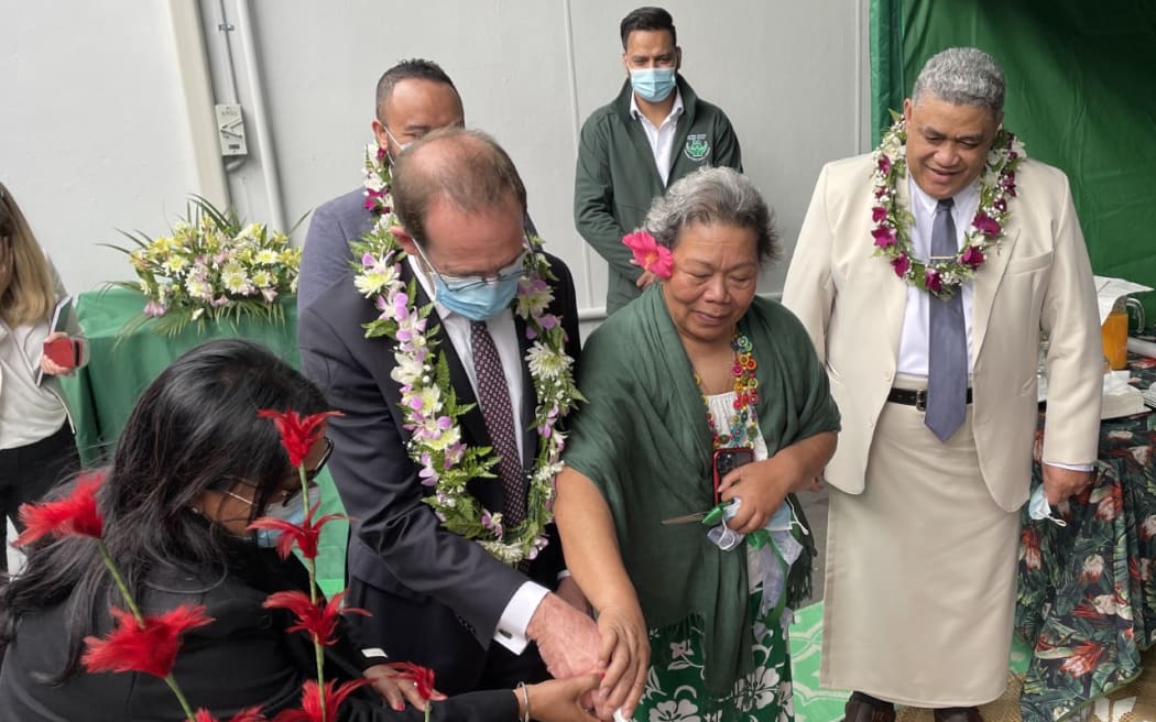 Minister Andrew Little cuts a cake at the Pasefika Family Health Group in Auckland to celebrate the administration of the flu vaccine exceeding the 1 million mark so far this winter.