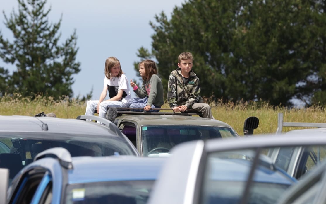 Children waiting at a checkpoint at the start of the inland road out of Kaikoura.