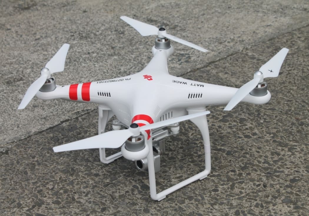 A closeup image Karekare Surf Life Saving Club's new drone, sitting on conccrete outside the club.