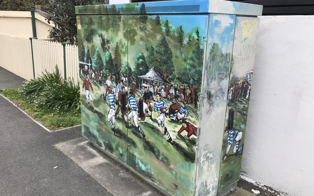 At Nelson's Botanical Reserve in 1870, two local teams played the first rugby game in New Zealand. The historic first game is remembered in an artistic rendition on an electrical box.