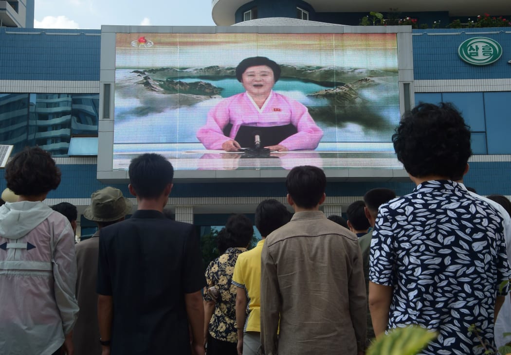 Residents in Pyongjang watch a newsreader announces North Korea's  hydrogen bomb test on September 3, 2017.