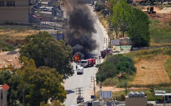 First responders attend to a burning vehicle targeted by an Israeli drone attack in the southern Lebanese city of Nabatieh on June 5, 2026. Israeli strikes overnight in the south Lebanon city of Tyre killed seven people, a source from Lebanon's civil defence told AFP on June 5, despite a ceasefire in the Israel-Hezbollah war.