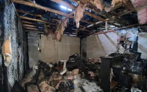 Inside the family's destroyed kitchen after the fire in their Rothesay Bay home in Auckland on December 22.