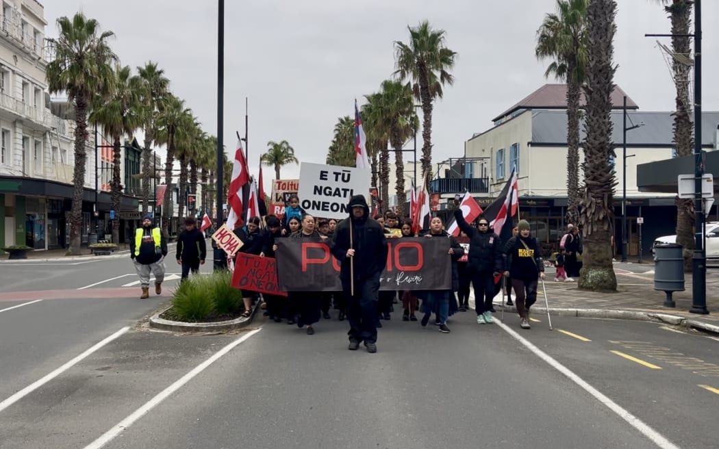 A Ngāti Oneone hikoi makes its way up the main road of Gisborne en route to Te Pa Eketu Shed on Hirini St where an occupation is taking place as the hapū calls for the return of lands.
