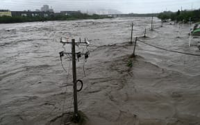 The Yongding River overflows after heavy rain in Mentougou district in Beijing on 31 July 2023.