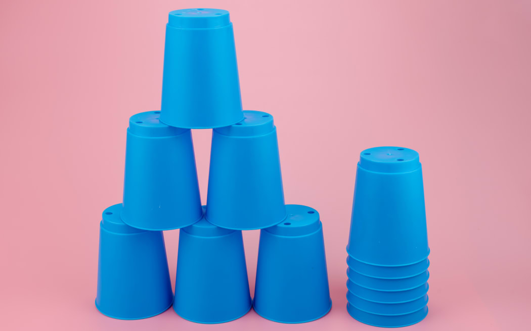 blue stacks plastic cups. Speed stack cup on pink background