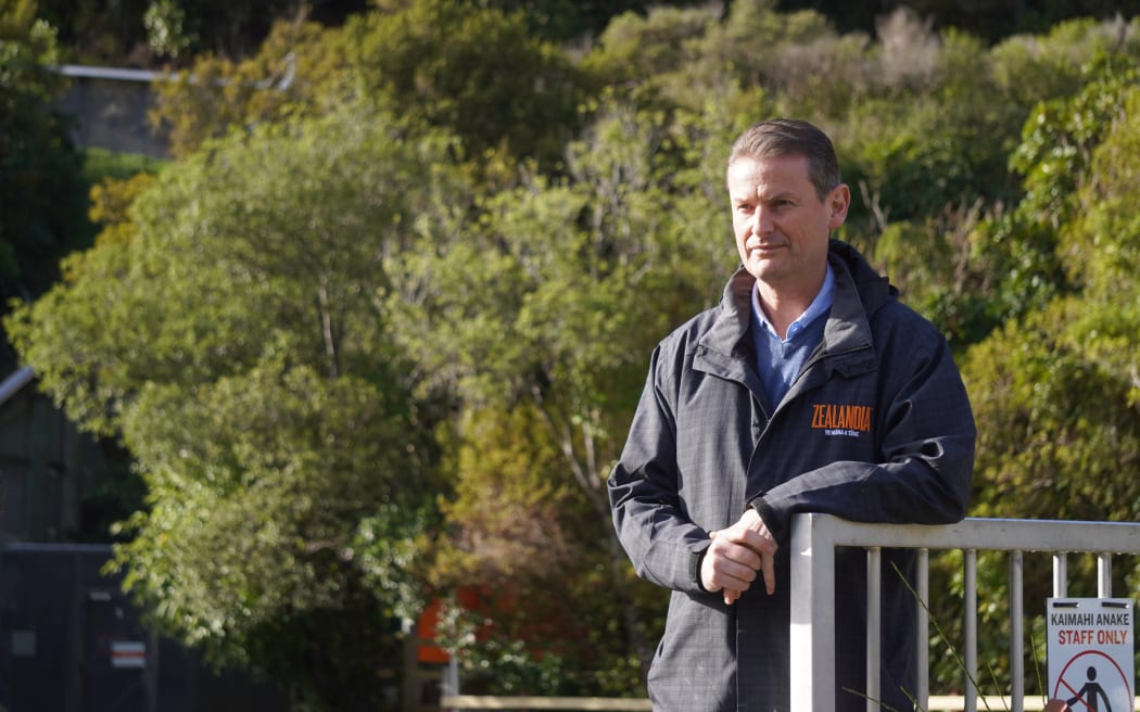 Zealandia's chief financial officer John Diggins watches on, as the Navy crew sets up the boat for the lake survey.