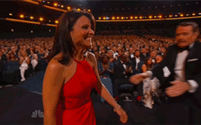 Julia louis-dreyfuss being kissed by Bryan Cranston