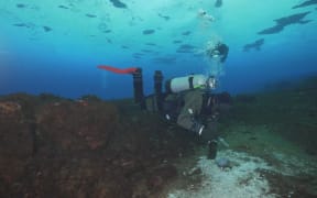 Divers collecting sample to measure methane at Cape Evans, Antarctica. Single use