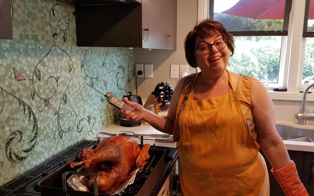 Susan Templer checks the Thanksgiving turkey at a recent dinner.