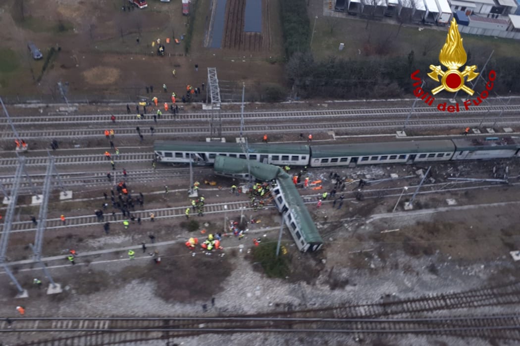 This handout picture released by the Italian Vigili del Fuoco shows firemen working on the site of a train derailment, on January 25, 2018 near Milan.