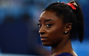 Simone Biles gets ready to compete in the uneven bars event of the  artistic gymnastics women's qualification during the Tokyo 2020 Olympic Games on 25 July 2021.