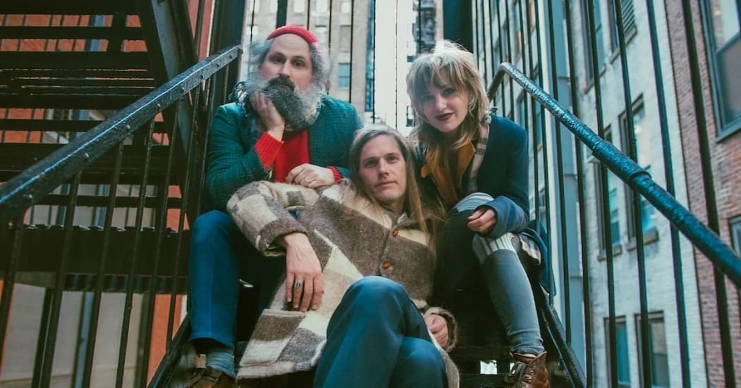 The American trio Bonny Light Horseman ... promo shot sitting on a fire escape staircase