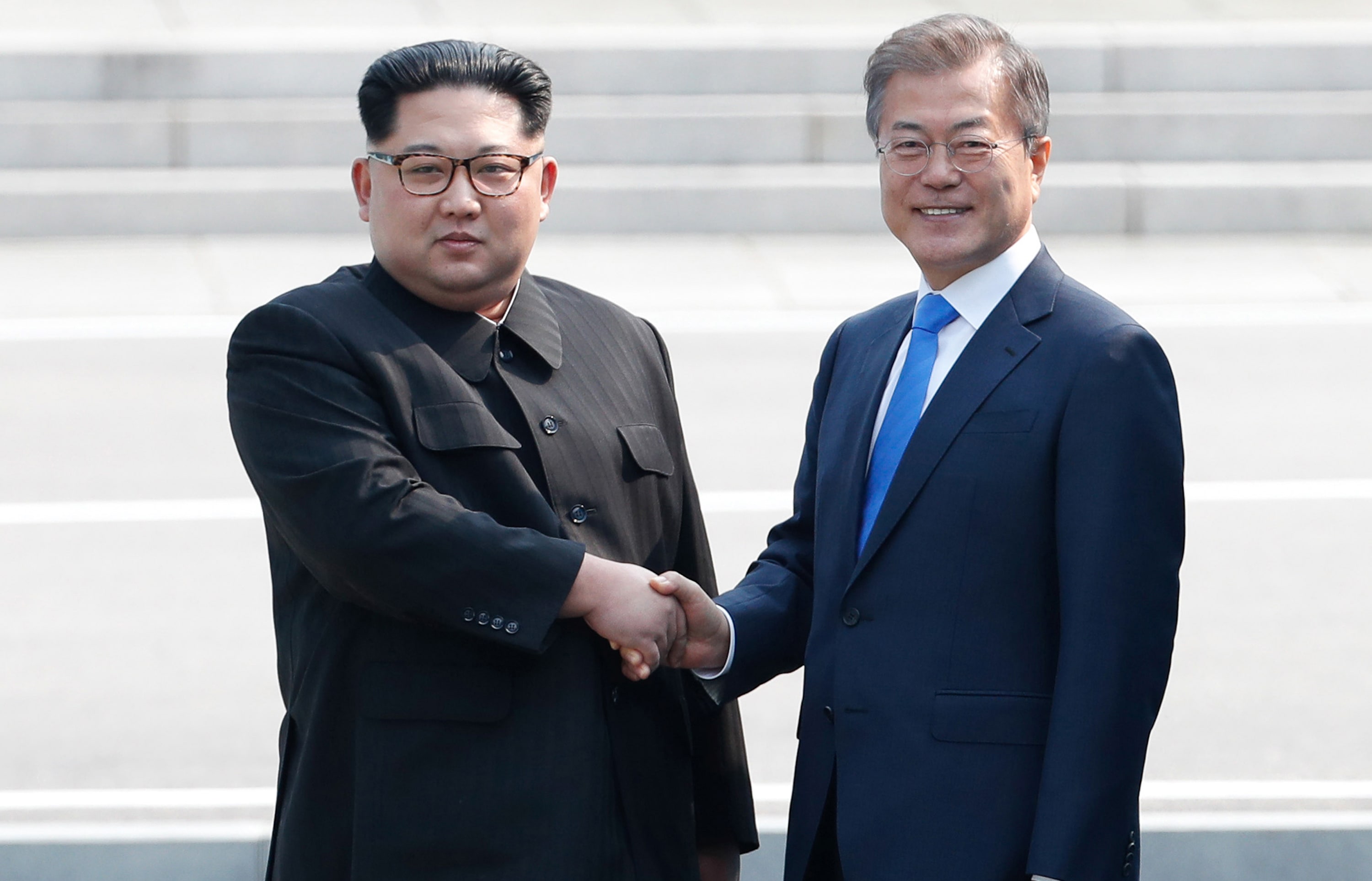 North Korea's leader Kim Jong Un shakes hands with South Korea's President Moon Jae-in at the Military Demarcation Line.