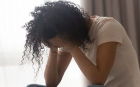 Depressed african American young woman sit at home feel desperate down suffering from relationships problems breakup, upset black girl crying having life troubles,