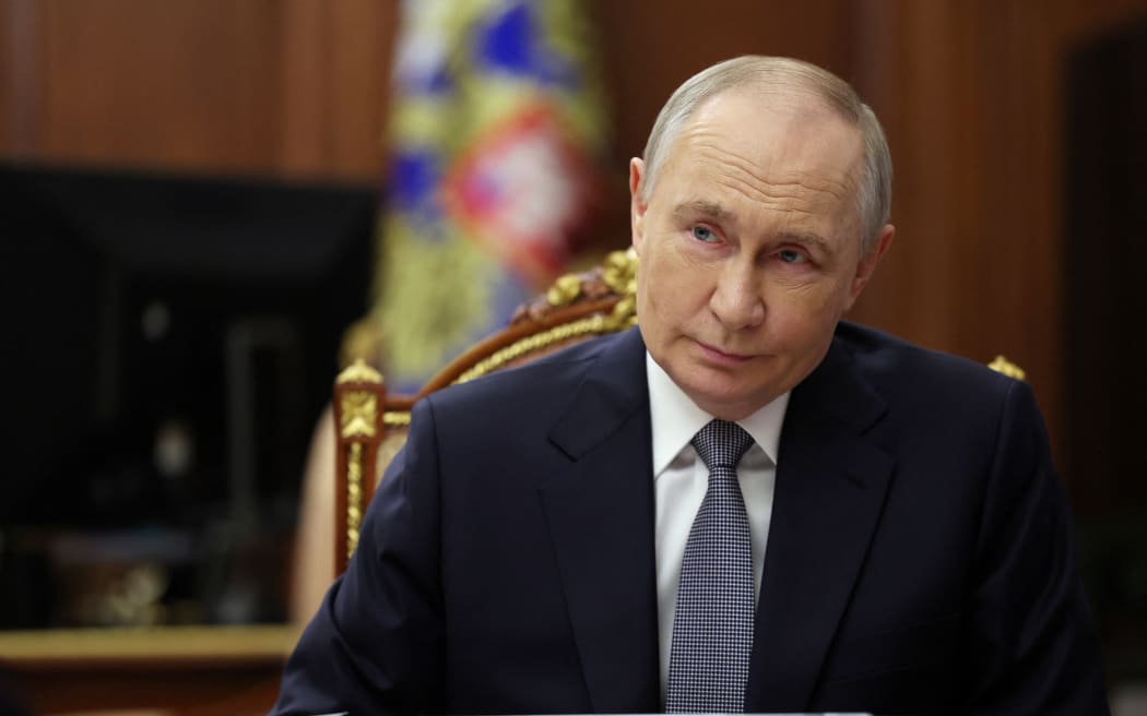 In this pool photograph distributed by the Russian state agency Sputnik, Russia's President Vladimir Putin meets with Russia's Minister of Culture in Moscow on April 4, 2025. (Photo by Vyacheslav PROKOFYEV / POOL / AFP)