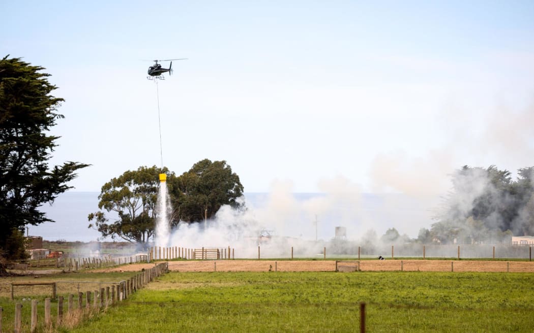 Helicopter dampening a fire oh SH1 in Kaikōura.
