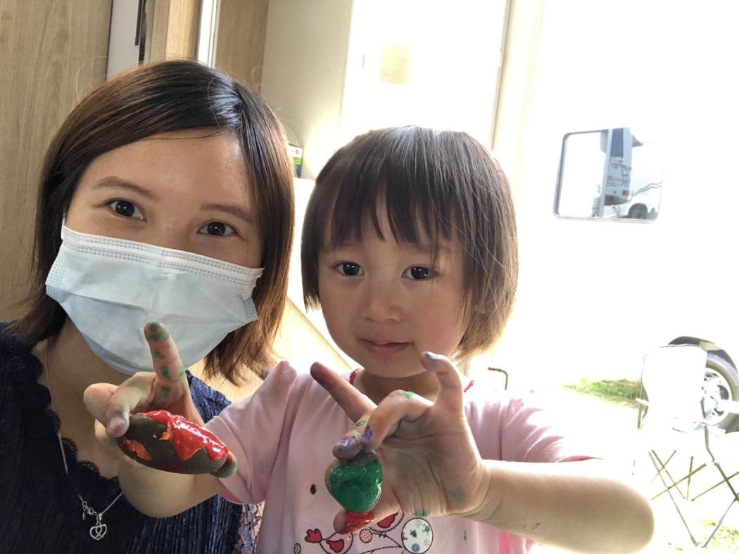 Lily Gao painting rocks with her 2yo daughter Elysse in the campervan.
