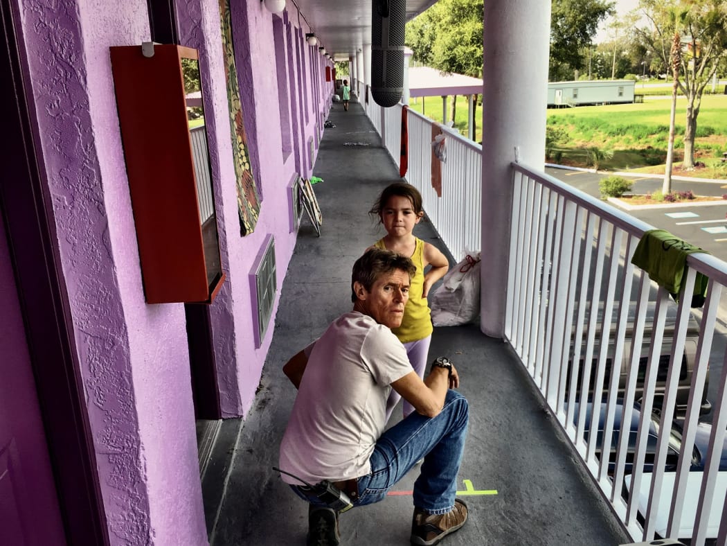 Willem Dafoe and Brooklynn Prince try to work something out in The Florida Project.