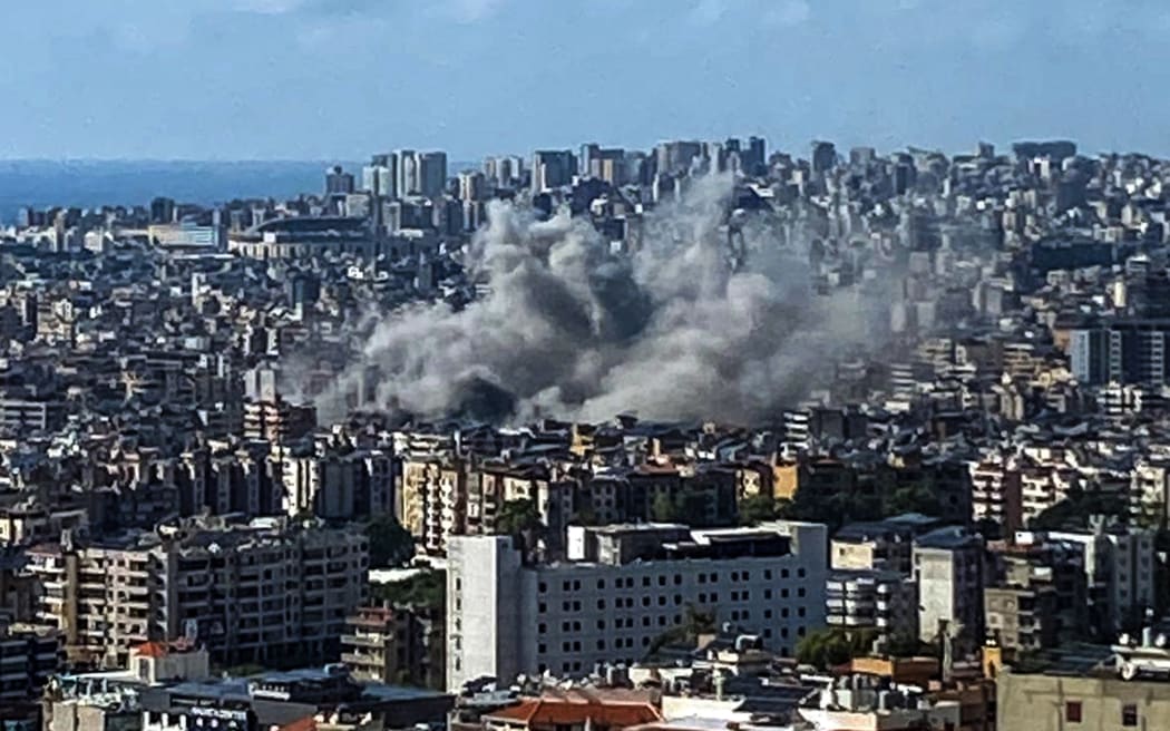 Thick smoke rises above the southern suburbs of Beirut after an Israel strike on September 20, 2024. The strike on Hezbollah's stronghold in Lebanon's capital Beirut reportedly killed at least eight people and wounded dozens of others, with a source close to the movement saying a top military leader was dead. (Photo by AFP)