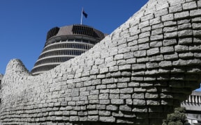 The Beehive dwarfed by a sculpture in the park across from it