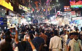 People throng a street near the Jama Masjid in the old quarters of New Delhi on April 19, 2023. - India is set to overtake China as the world's most populous country by the end of June, UN estimates showed on April 19, 2023, posing huge challenges to a nation with creaking infrastructure and insufficient jobs for millions of young people. (Photo by Arun SANKAR / AFP)