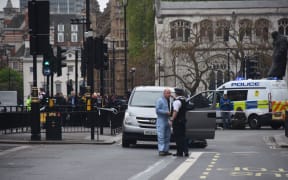 Police patrol near Westminster, where an earlier terror arrest took place. The two events were unrelated, Scotland Yard said.