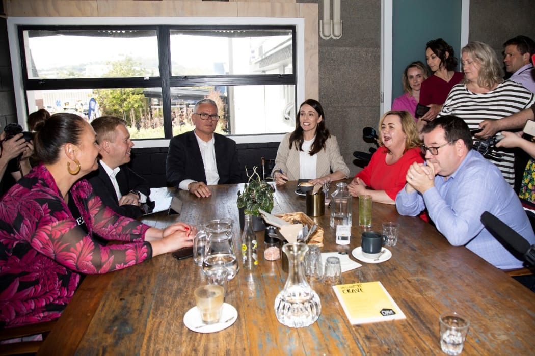 New Zealand Prime Minister Jacinda Ardern (centre R) speaks with senior members of parliament a day after her landslide election win.