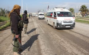 Syrian Red Crescent ambulances carry the sick and wounded from government-held towns to the rebel-held Rashideen, west of Aleppo.