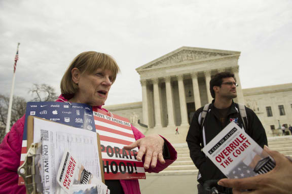 Joan Stallard (left) protesting outside the Supreme Court in Washington DC as Scott Dorn looks on.