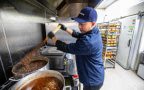 Samraksmey (Sam) So, owner of Rosedale Bakery & Café, prepares a huge pot with mince filling for his pies.