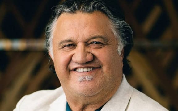 Pio Terei smiling in a white suit jacket