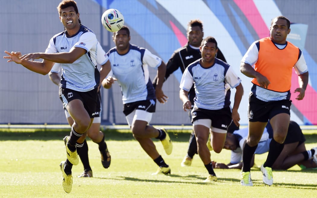 Fiji's fly half Ben Volavola (L) passes the ball during a training session on September 27, 2015 in Swansea.