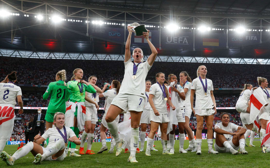 Beth Mead of England celebrates lifting the UEFA European Women's Football Championship trophy, 2022.