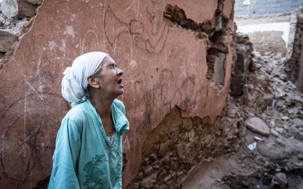 A woman stands in front of her earthquake-damaged house in the old city in Marrakesh on September 9, 2023.
